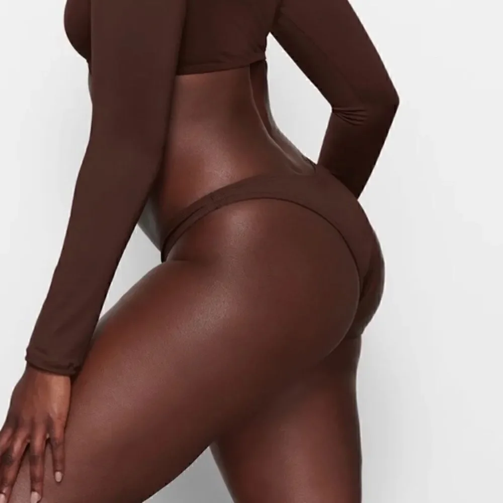 SKIMS SWIM BIKINI bottoms in chocolate brown